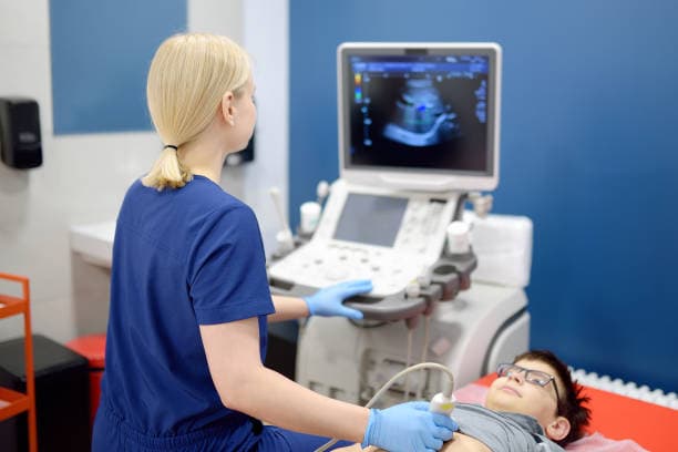 Medical professional performing ultrasound for appendicitis in children