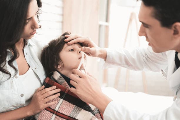 Doctor examining a child with flu