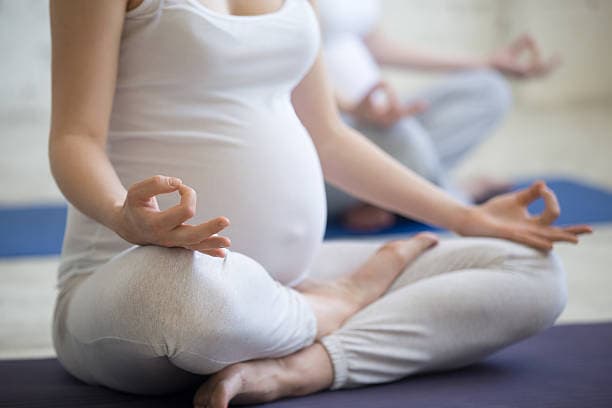 Pregnant woman practicing yoga
