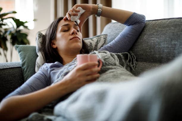 Adult experiencing flu symptoms
