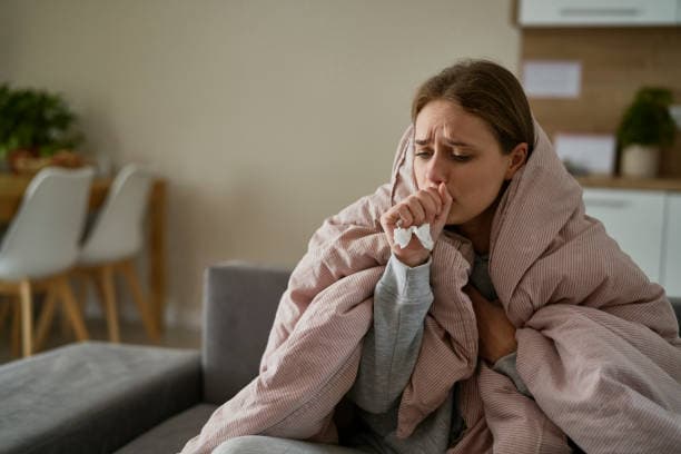 Person experiencing flu symptoms without fever