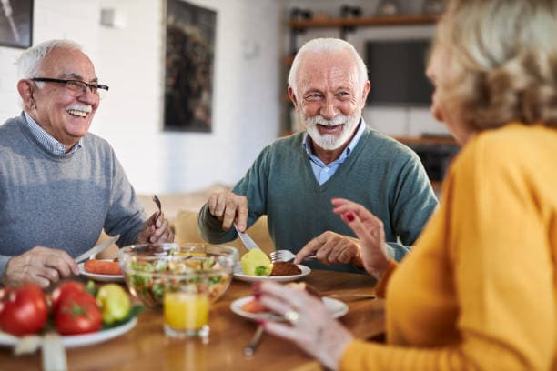 Senior preparing a healthy diet plan with fresh fruits and vegetables