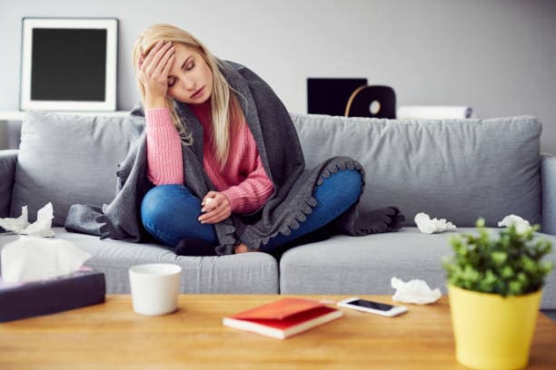 Person resting at home with flu symptoms