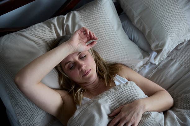 Night sweats during menopause woman in bed