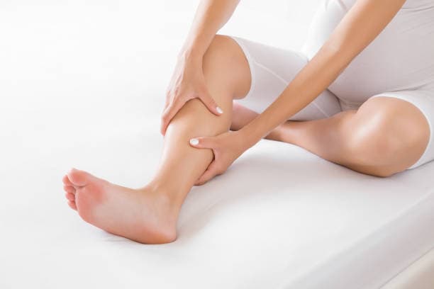 Woman experiencing restless legs during pregnancy