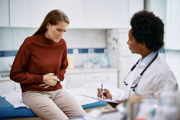 Doctor consulting patient on stomach issues