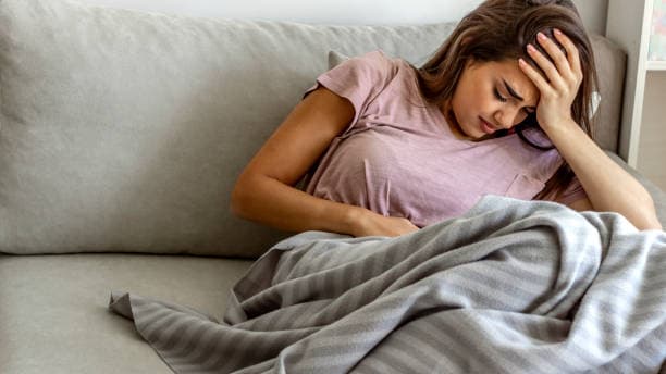 Person clutching stomach in stress