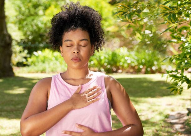 Person practicing deep breathing to relieve stress
